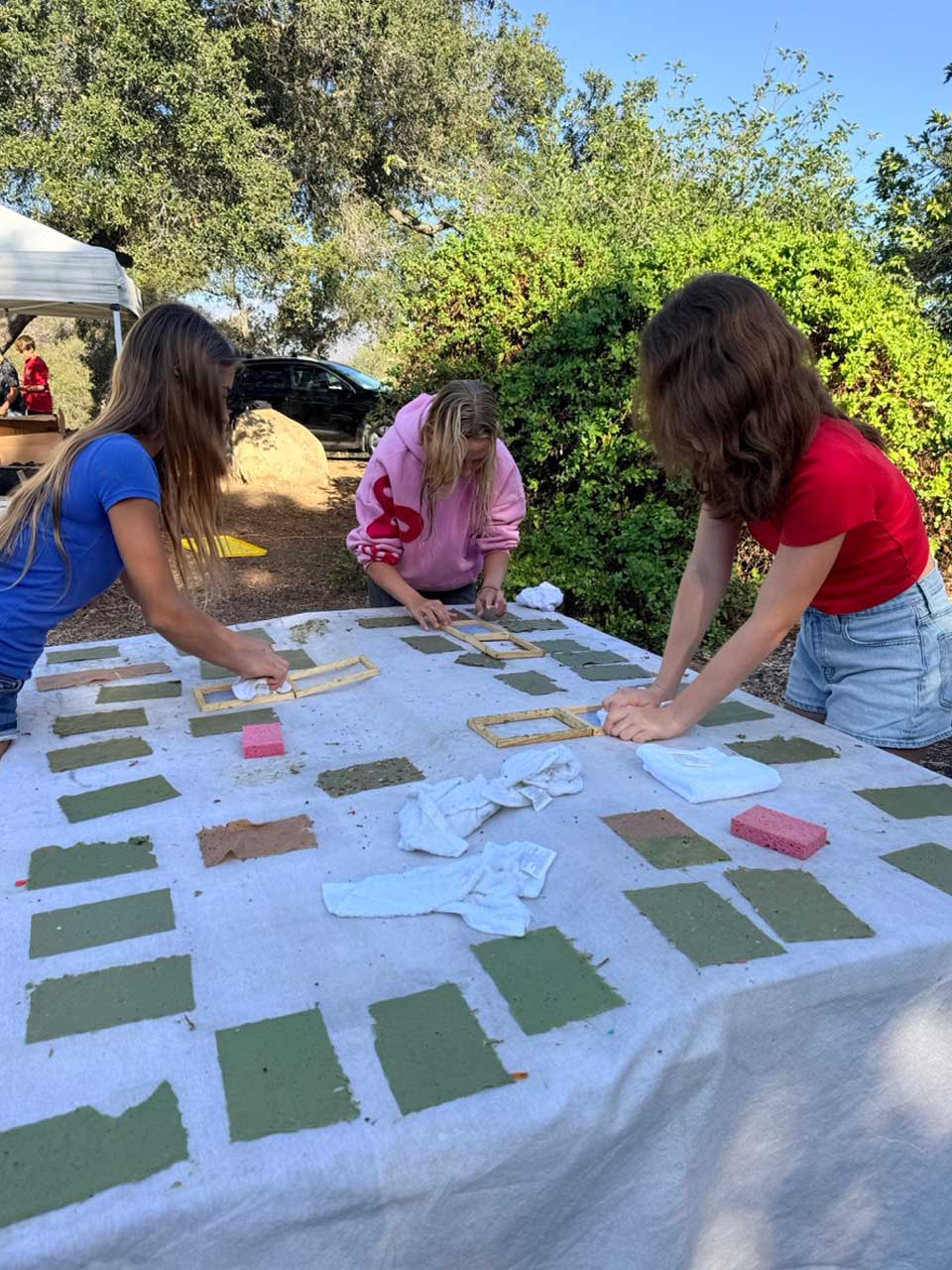 students making paper in the garden