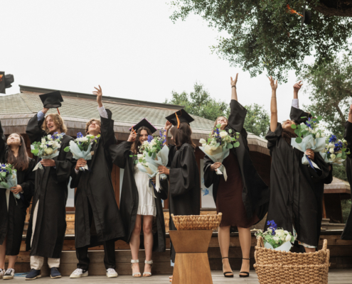 High School Graduates throw their caps
